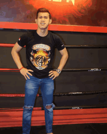 a man stands in a boxing ring wearing a shirt that says 4th anniversary