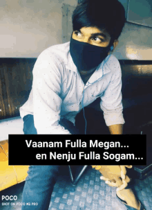 a man wearing a mask with the words " vaanam fulla megan ... en nenju fulla sogam ... "