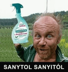 a man with a beard is holding a bottle of sanytol disinfectant