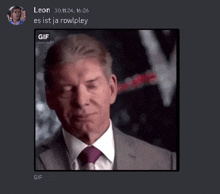 a gif of a man in a suit and tie is being displayed