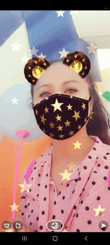 a woman wearing a face mask with stars on it