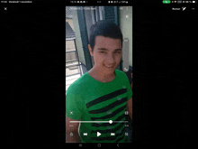 a phone screen shows a video of a young man