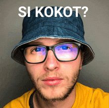 a man wearing glasses and a hat with the words si kokot on it