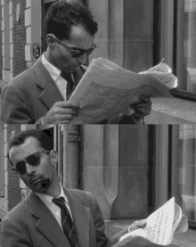 a man in a suit and tie is reading a newspaper with a pipe in his mouth