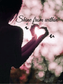 a woman making a heart with her hands with the words shine from within