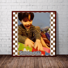 a framed picture of a young boy with the name shadow on it