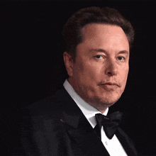 a man in a tuxedo with the name elon musk on the bottom