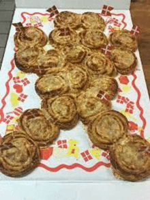 a bunch of pastries are sitting on top of a white table .