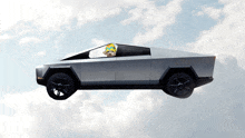 a silver car with a teddy bear in the driver 's seat flying through the air