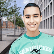 a young man wearing a green shirt that says dominion