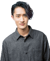 a young man wearing a gray shirt and a necklace looks at the camera