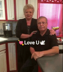 a man and woman are posing for a picture in a kitchen with the words love u