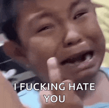 a little boy is crying and giving the middle finger while saying i fucking hate you