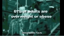 a group of people are standing in front of a sign that says ' weight loss facts ' on it