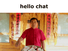 a man in a red shirt is holding a basket of food in front of a wooden building with chinese writing on the wall behind him