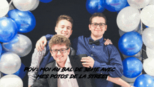 a group of young men are posing for a picture in front of balloons