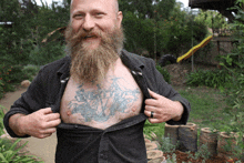 a man with a beard has a tattoo on his chest that says ' everybody 's a pirate '