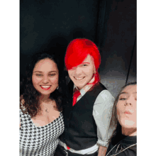 a man with red hair is smiling with two other women