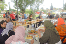 a group of people sitting around a table eating