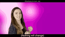 a woman is standing in front of a purple background and making a fist .