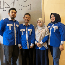 a group of people wearing blue shirts with letters t on them