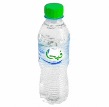 a bottle of water with a green cap and arabic writing on the label .