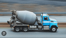 a concrete mixer truck is driving down the road