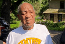 an elderly man wearing a white shirt that says central