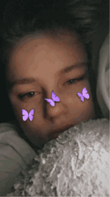 a girl with three purple butterflies on her face