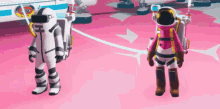 a couple of astronauts standing next to each other on a pink surface