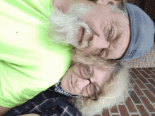 a man with a beard and a woman with glasses are posing for a photo