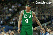 a boston celtics basketball player wearing a green jersey with the number 4 on it