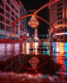 a reflection of a chandelier in a puddle in a city