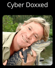 a picture of a man holding an alligator with the words cyber doxxed below him