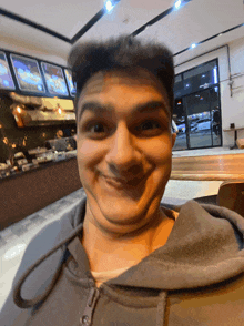 a man making a funny face in front of a food counter