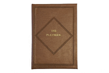 a brown leather playbook with a diamond shaped design