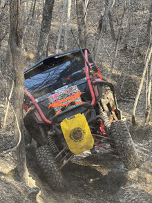 a red and black atv with a yellow towel on the back that says trail riders