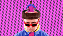 a man with a shaved head and sunglasses is holding a man in a pink shirt in his head .