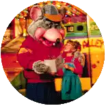 a chuck e cheese mascot is holding a little girl in his arms