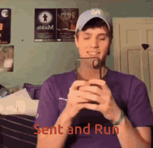 a man in a purple shirt is holding a cell phone and the words sent and run are on the bottom