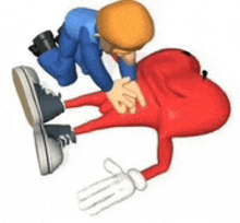 a cartoon character is laying on the ground and a man is kneeling down to help him .