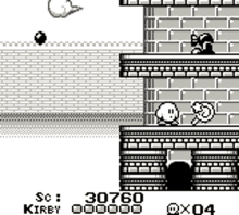 a black and white image of a video game with kirby and a brick wall .