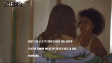 a woman looking at herself in a mirror with the words three on the top