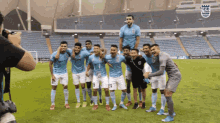 a group of soccer players are posing for a picture on a field with the number 9 on their jersey