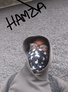 a person wearing a hoodie and glasses with hamza written on the bottom