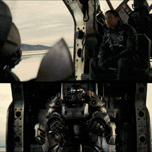 a man sits in the cockpit of a fighter jet with a robot in the back