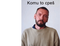 a man with a beard is wearing a sweater with the words komu to cpes written on it .