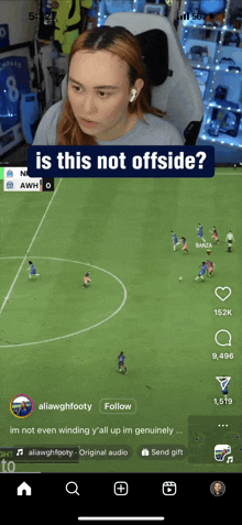 a woman is watching a soccer game on a cell phone and says is this not offside