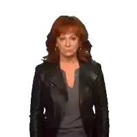 a woman with red hair is wearing a black jacket