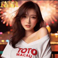 a woman wearing a toto macau shirt stands in front of a fireworks display